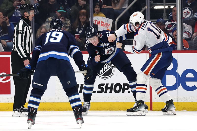 Jan 8, 2026; Winnipeg, Manitoba, CAN; Winnipeg Jets defenseman Logan Stanley (64) fights with Edmonton Oilers center Trent Frederic (10) in the second period at Canada Life Centre. Mandatory Credit: James Carey Lauder-Imagn Images