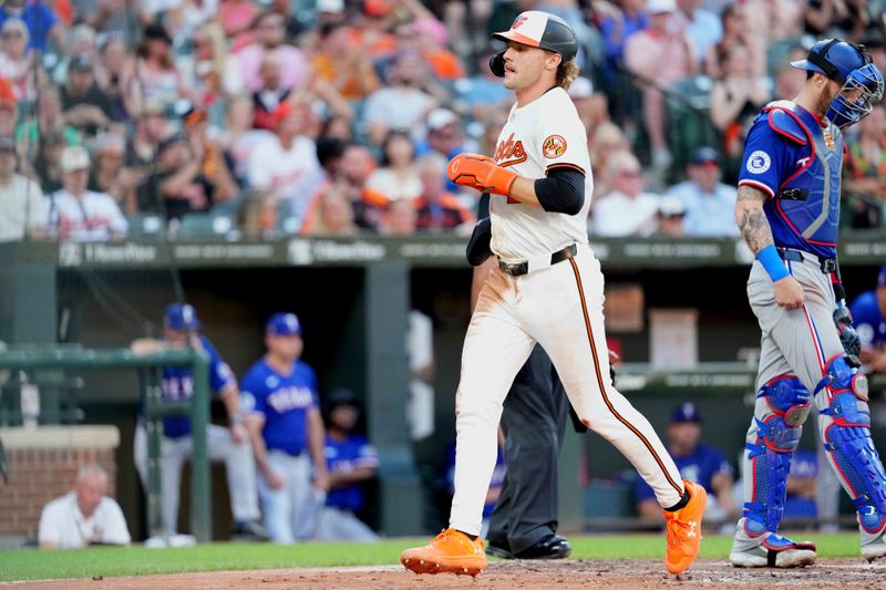 Jun 27, 2024; Baltimore, Maryland, USA; Baltimore Orioles shortstop Gunnar Henderson (2) scores on a sacrifice fly ball by first baseman Ryan Mountcastle (not shown) in the third inning against the Texas Rangers at Oriole Park at Camden Yards. Mandatory Credit: Mitch Stringer-USA TODAY Sports