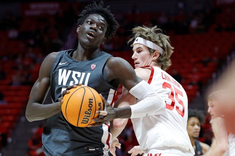 Jan 19, 2023; Salt Lake City, Utah, USA; Washington State Cougars forward Mouhamed Gueye (35) looks to drive against Utah Utes center Branden Carlson (35) in the first half at Jon M. Huntsman Center. Mandatory Credit: Jeffrey Swinger-USA TODAY Sports