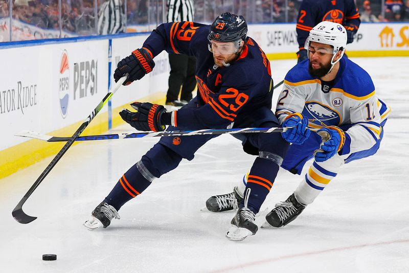 Mar 21, 2024; Edmonton, Alberta, CAN; Edmonton Oilers forward Leon Draisaitl (29) protects the puck from forward Buffalo Sabres forward Jordan Greenway (12) during the third period at Rogers Place. Mandatory Credit: Perry Nelson-USA TODAY Sports