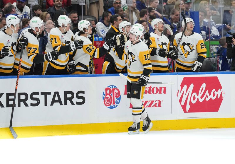 Apr 8, 2024; Toronto, Ontario, CAN; Pittsburgh Penguins left wing Drew O'Connor (10) celebrates at the bench after scoring a goal against the Toronto Maple Leafs during the third period at Scotiabank Arena. Mandatory Credit: Nick Turchiaro-USA TODAY Sports