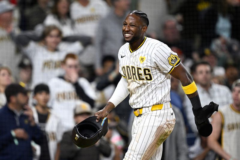 Jun 11, 2024; San Diego, California, USA; San Diego Padres left fielder Jurickson Profar (10) smiles after being tagged out at home during the fifth inning against the Oakland Athletics at Petco Park. Mandatory Credit: Orlando Ramirez-USA TODAY Sports