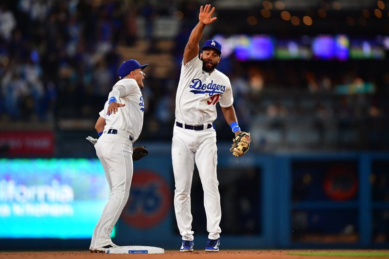 Aug 15, 2023; Los Angeles, California, USA; Los Angeles Dodgers shortstop Miguel Rojas (11) and second baseman Amed Rosario (31) celebrate the victory against the Milwaukee Brewers at Dodger Stadium. Mandatory Credit: Gary A. Vasquez-USA TODAY Sports