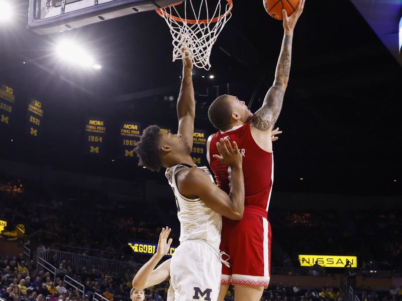 Feb 8, 2023; Ann Arbor, Michigan, USA;  Nebraska Cornhuskers guard C.J. Wilcher (0) shoots on Michigan Wolverines guard Jace Howard (25) in the second half at Crisler Center. Mandatory Credit: Rick Osentoski-USA TODAY Sports