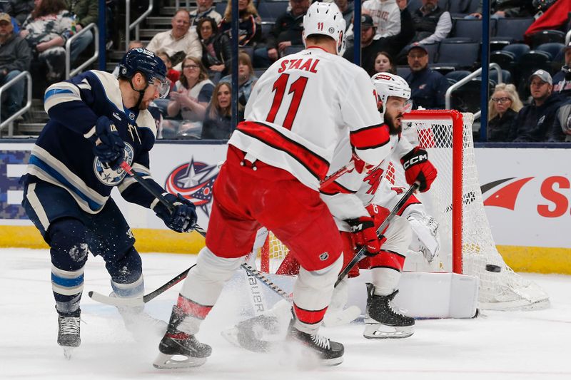 Feb 29, 2024; Columbus, Ohio, USA; Columbus Blue Jackets center Sean Kuraly (7) and Carolina Hurricanes center Jordan Staal (11) chase down a loose puck during the first period at Nationwide Arena. Mandatory Credit: Russell LaBounty-USA TODAY Sports