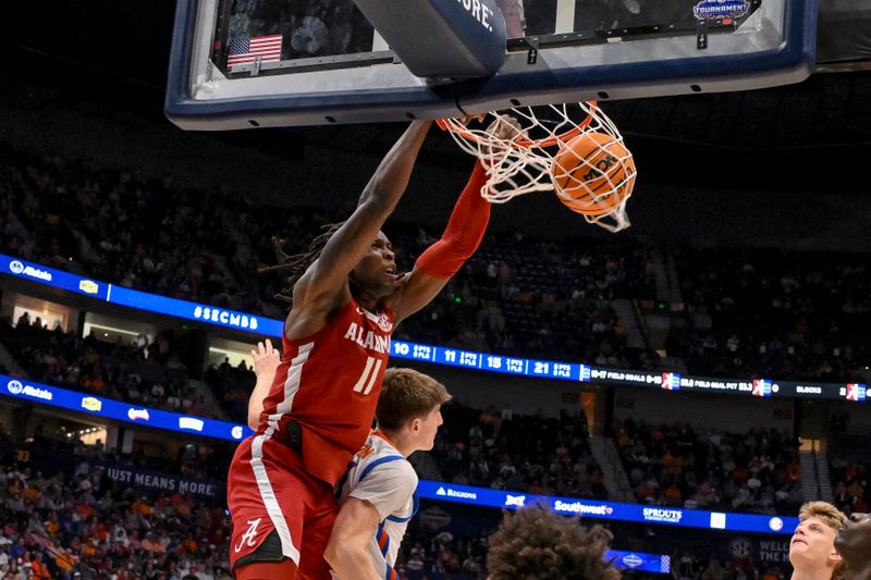 Mar 15, 2025; Nashville, TN, USA;  Alabama Crimson Tide center Clifford Omoruyi (11) dunks the ball over Florida Gators forward Alex Condon (21) during the first half at Bridgestone Arena. Mandatory Credit: Steve Roberts-Imagn Images