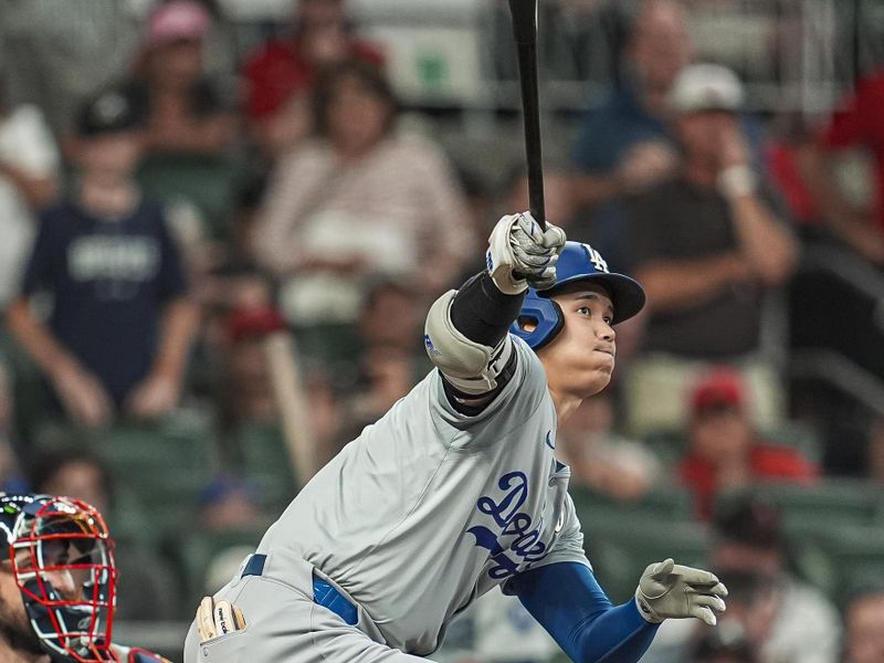 Sep 15, 2024; Cumberland, Georgia, USA; Los Angeles Dodgers designated hitter Shohei Ohtani (17) hits a double to drive in a run against the Atlanta Braves during the seventh inning at Truist Park. Mandatory Credit: Dale Zanine-Imagn Images
