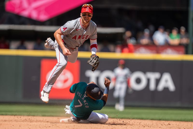 Jul 24, 2024; Seattle, Washington, USA;  Los Angeles Angels second baseman Brandon Drury (23) attempts to turn a double play after forcing out Seattle Mariners second baseman Jorge Polanco (7) at second base during the sixth inning at T-Mobile Park. Mandatory Credit: Stephen Brashear-USA TODAY Sports