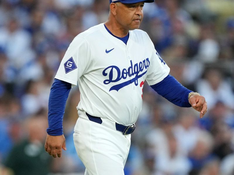 Jun 15, 2024; Los Angeles, California, USA; Los Angeles Dodgers manager Dave Roberts (30) walks to the pitcher’s mound during the game against the Kansas City Royals at Dodger Stadium. Mandatory Credit: Kirby Lee-USA TODAY Sports