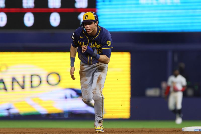 May 20, 2024; Miami, Florida, USA; Milwaukee Brewers left fielder Christian Yelich (22) runs toward third base after a throwing error by the Miami Marlins during the sixth inning at loanDepot Park. Mandatory Credit: Sam Navarro-USA TODAY Sports