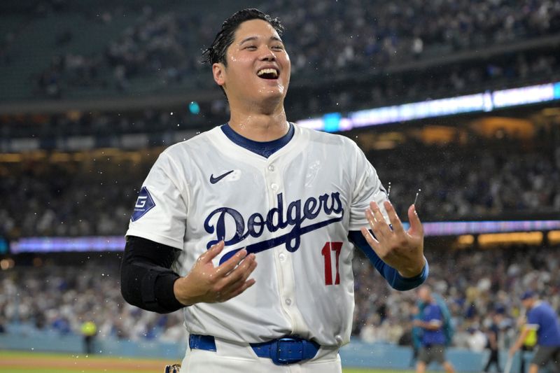 Aug 23, 2024; Los Angeles, California, USA;  Los Angeles Dodgers designated hitter Shohei Ohtani (17) smiles after he was doused with ice water after hitting a walk-off grand slam home run, his 40th of the season, in the ninth inning against the Tampa Bay Rays at Dodger Stadium. Watson. Mandatory Credit: Jayne Kamin-Oncea-USA TODAY Sports