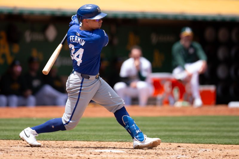 Jun 20, 2024; Oakland, California, USA; Kansas City Royals designated hitter Freddy Fermin (34) follows through on his single against the Oakland Athletics during the sixth inning at Oakland-Alameda County Coliseum. Mandatory Credit: D. Ross Cameron-USA TODAY Sports