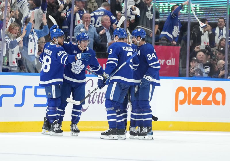 Oct 11, 2023; Toronto, Ontario, CAN; Toronto Maple Leafs right wing William Nylander (88) scores a goal and celebrates with right wing Mitchell Marner (16) against the Montreal Canadiens during the second period at Scotiabank Arena. Mandatory Credit: Nick Turchiaro-USA TODAY Sports