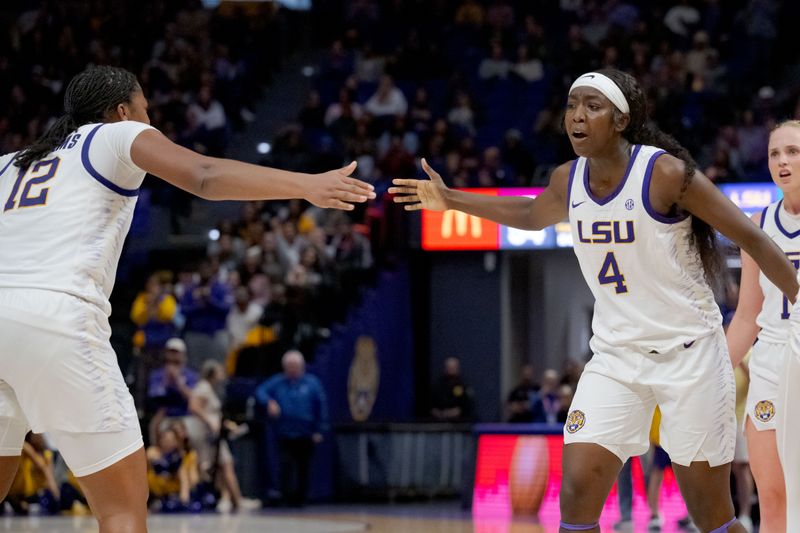 Nov 30, 2023; Baton Rouge, Louisiana, USA; LSU Lady Tigers guard Mikaylah Williams (12) celebrates a score and a foul shot by LSU Lady Tigers guard Flau'jae Johnson (4) during the second half against the Virginia Tech Hokies at Pete Maravich Assembly Center. Mandatory Credit: Matthew Hinton-USA TODAY Sports