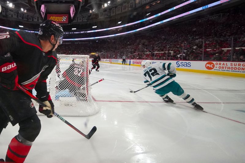 Oct 27, 2023; Raleigh, North Carolina, USA; San Jose Sharks center William Eklund (72) comes out inferno not Carolina Hurricanes goaltender Antti Raanta (32) during the second period at PNC Arena. Mandatory Credit: James Guillory-USA TODAY Sports