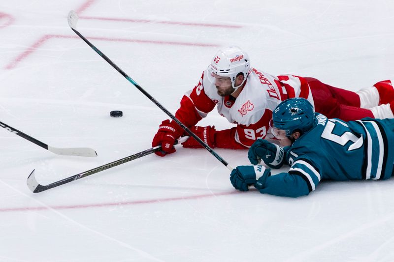 Nov 2, 2025; San Jose, California, USA;  Detroit Red Wings right wing Alex Debrincat (93) and San Jose Sharks right wing Collin Graf (51) collide during the third period at SAP Center at San Jose. Mandatory Credit: John Hefti-Imagn Images