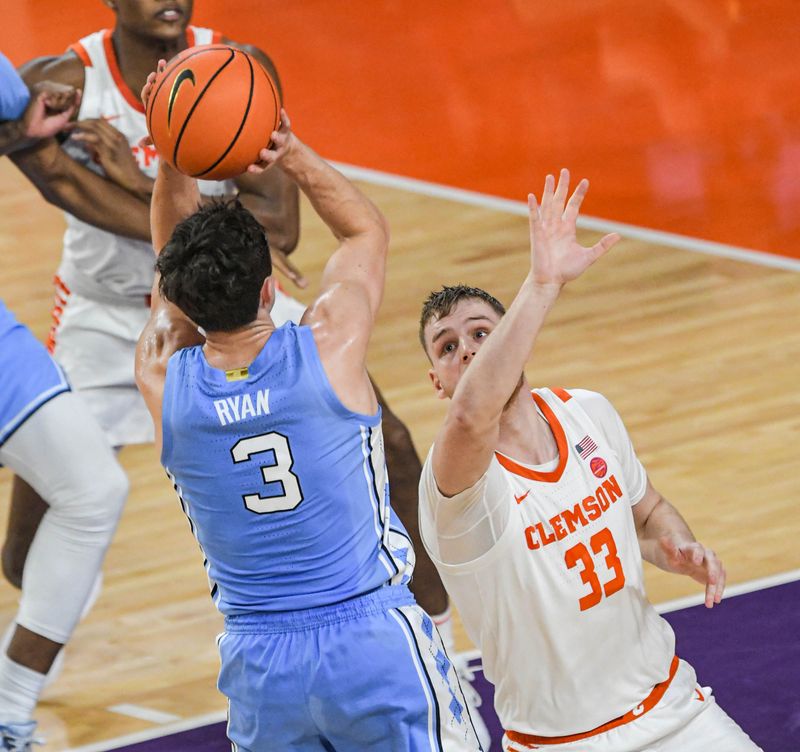 Jan 6, 2024; Clemson, South Carolina, USA; University of North Carolina guard Cormac Ryan (3) shoots the ball near Clemson graduate Bas Leyte (33) during the first half  at Littlejohn Coliseum. Mandatory Credit: Ken Ruinard-USA TODAY Sports