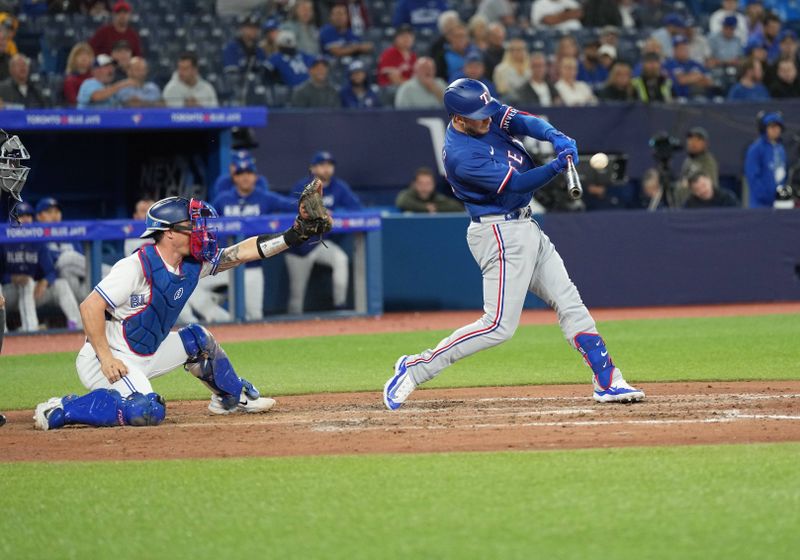 Sep 13, 2023; Toronto, Ontario, CAN; Texas Rangers designated hitter Mitch Garver (18) hits a three run home run against the Toronto Blue Jays during the ninth inning at Rogers Centre. Mandatory Credit: Nick Turchiaro-USA TODAY Sports