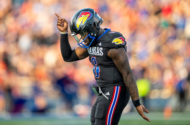 Sep 8, 2023; Lawrence, Kansas, USA; Kansas Jayhawks quarterback Jalon Daniels (6) celebrates after a touchdown against the Illinois Fighting Illini during the first half at David Booth Kansas Memorial Stadium. Mandatory Credit: Jay Biggerstaff-USA TODAY Sports