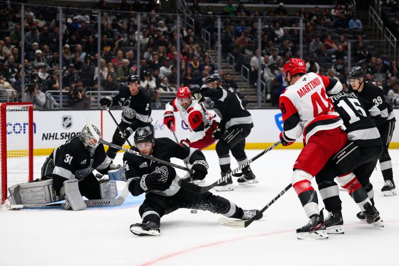 Oct 18, 2025; Los Angeles, California, USA; Los Angeles Kings right wing Alex Laferriere (14) falls trying to block a shot during the third period against the Carolina Hurricanes at Crypto.com Arena. Mandatory Credit: William Liang-Imagn Images