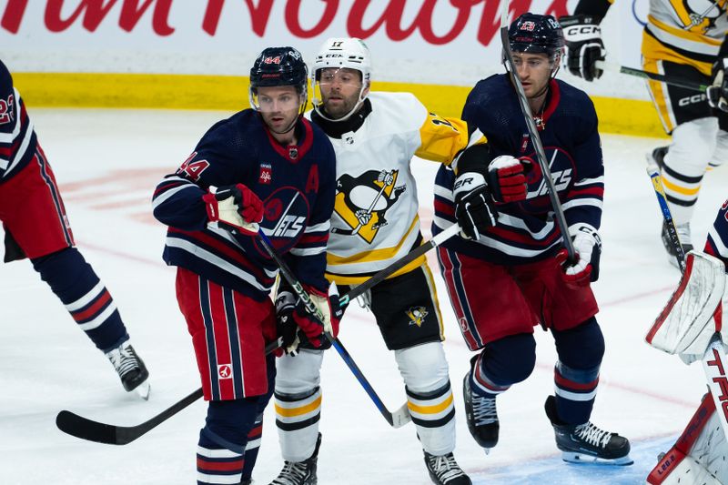 Feb 10, 2024; Winnipeg, Manitoba, CAN;  Winnipeg Jets defenseman Josh Morrissey (44), Pittsburgh Penguins forward Bryan Rust (17) and Winnipeg Jets forward Gabriel Vilardi (13) look for the puck during the third period at Canada Life Centre. Mandatory Credit: Terrence Lee-USA TODAY Sports