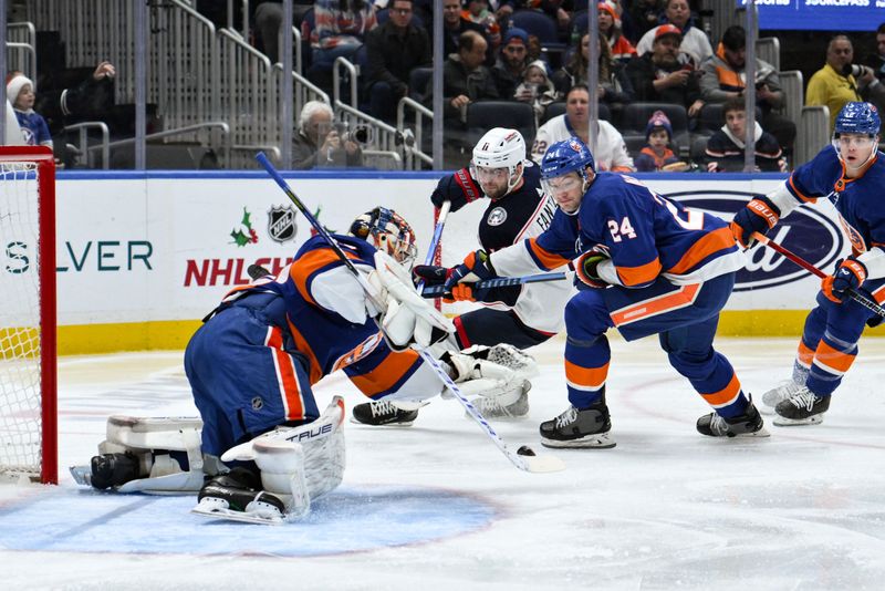 Dec 7, 2023; Elmont, New York, USA; New York Islanders goaltender Semyon Varlamov (40) makes a save against Columbus Blue Jackets center Adam Fantilli (11) during the first period at UBS Arena. Mandatory Credit: John Jones-USA TODAY Sports