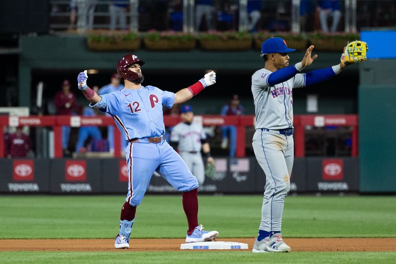 May 16, 2024; Philadelphia, Pennsylvania, USA; Philadelphia Phillies designated hitter Kyle Schwarber (12) reacts behind New York Mets shortstop Francisco Lindor (12) after his RBI double during the seventh inning at Citizens Bank Park. Mandatory Credit: Bill Streicher-USA TODAY Sports