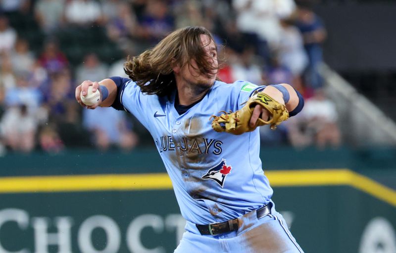 Sep 18, 2024; Arlington, Texas, USA;  Toronto Blue Jays third baseman Addison Barger (47) throws to first base during the third inning against the Texas Rangers at Globe Life Field. Mandatory Credit: Kevin Jairaj-Imagn Images