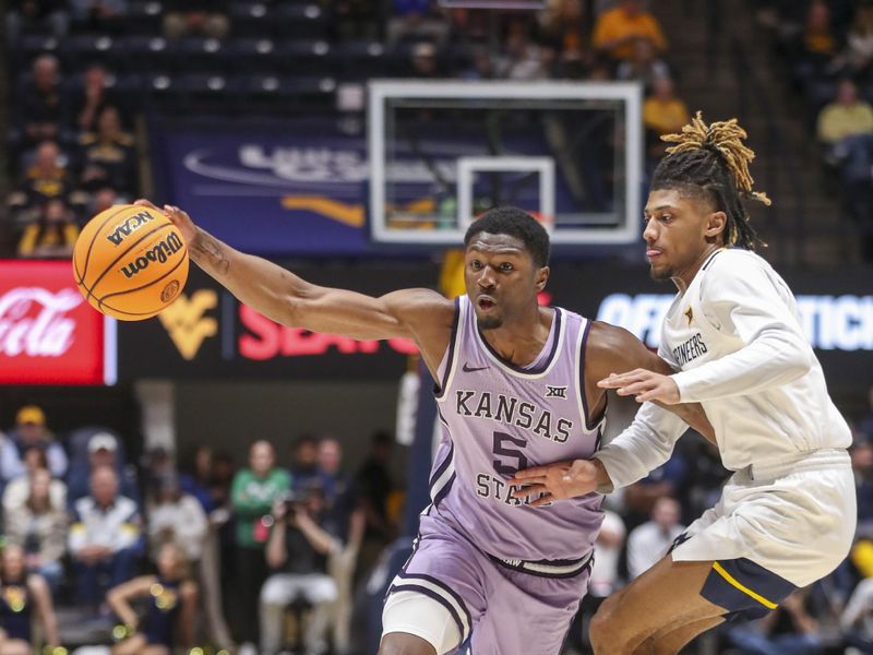 Jan 9, 2024; Morgantown, West Virginia, USA; Kansas State Wildcats guard Cam Carter (5) dribbles against West Virginia Mountaineers guard Noah Farrakhan (1) during the first half at WVU Coliseum. Mandatory Credit: Ben Queen-USA TODAY Sports