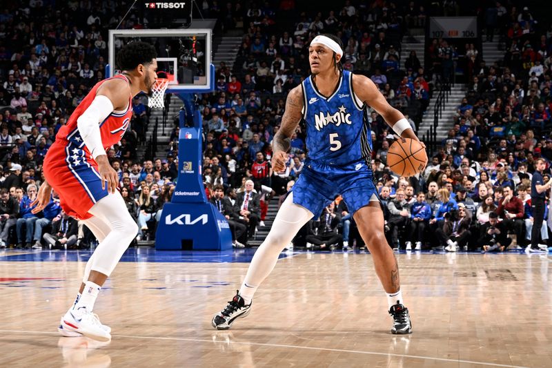 PHILADELPHIA, PA - APRIL 12: Paolo Banchero #5 of the Orlando Magic dribbles the ball during the game against the Philadelphia 76ers on April 12, 2024 at the Wells Fargo Center in Philadelphia, Pennsylvania NOTE TO USER: User expressly acknowledges and agrees that, by downloading and/or using this Photograph, user is consenting to the terms and conditions of the Getty Images License Agreement. Mandatory Copyright Notice: Copyright 2024 NBAE (Photo by David Dow/NBAE via Getty Images)