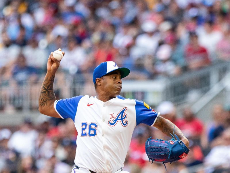 Jun 29, 2024; Cumberland, Georgia, USA; Atlanta Braves pitcher Raisel Iglesias (26) pitches against the Pittsburgh Pirates during the eighth inning at Truist Park. Mandatory Credit: Jordan Godfree-USA TODAY Sports