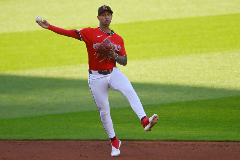 Apr 22, 2025; Cleveland, Ohio, USA; Cleveland Guardians shortstop Brayan Rocchio (4) throws to first base in the third inning against the New York Yankees at Progressive Field. Mandatory Credit: David Richard-Imagn Images