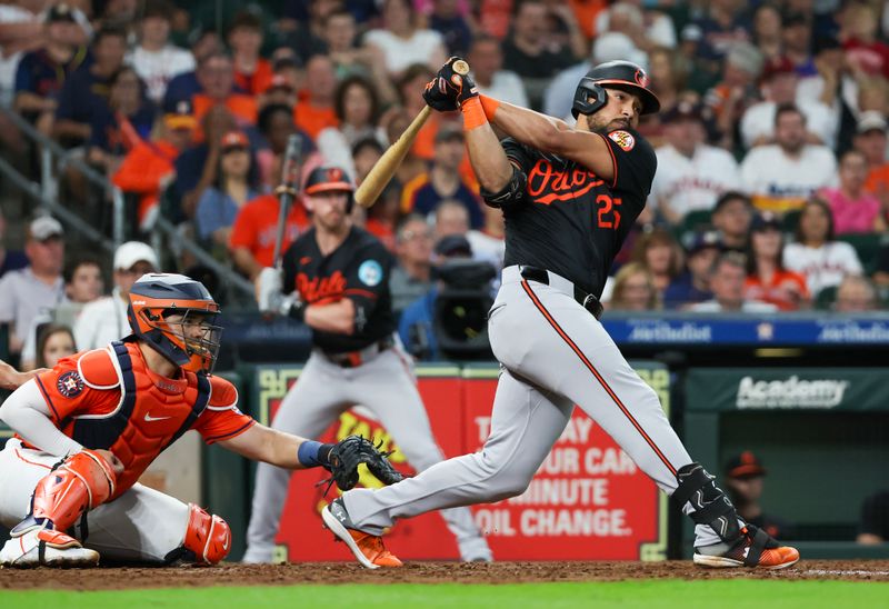 Jun 21, 2024; Houston, Texas, USA; Baltimore Orioles right fielder Anthony Santander (25) hits a RBI single against the Houston Astros in the third inning at Minute Maid Park. Mandatory Credit: Thomas Shea-USA TODAY Sports