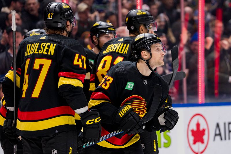 Dec 7, 2023; Vancouver, British Columbia, CAN; Vancouver Canucks defenseman Noah Juulsen (47) and forward Dakota Joshua (81) and forward Teddy Blueger (53) celebrate Blueger   s gaol against the Minnesota Wild in the third period at Rogers Arena. Vancouver won 2-0. Mandatory Credit: Bob Frid-USA TODAY Sports