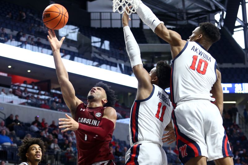 Feb 11, 2023; Oxford, Mississippi, USA; South Carolina Gamecocks guard Jacobi Wright (1) shoots as Mississippi Rebels guard Matthew Murrell (11) and forward Theo Akwuba (10) defends during the first half at The Sandy and John Black Pavilion at Ole Miss. Mandatory Credit: Petre Thomas-USA TODAY Sports