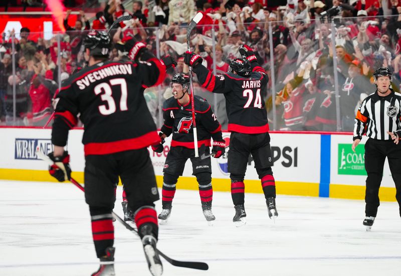 Apr 29, 2025; Raleigh, North Carolina, USA; Carolina Hurricanes center Sebastian Aho (20) scores the game wining goal in the second overtime against the New Jersey Devils in game five of the first round of the 2025 Stanley Cup Playoffs at Lenovo Center. Mandatory Credit: James Guillory-Imagn Images