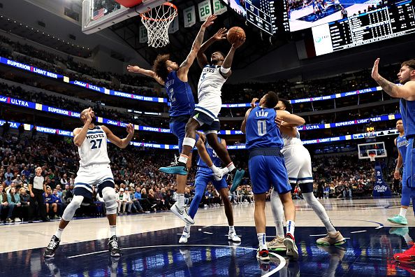 DALLAS, TEXAS - DECEMBER 14: Anthony Edwards #5 of the Minnesota Timberwolves drives to the basket against Dereck Lively II #2 of the Dallas Mavericks in the first half at American Airlines Center on December 14, 2023 in Dallas, Texas. NOTE TO USER: User expressly acknowledges and agrees that, by downloading and or using this photograph, User is consenting to the terms and conditions of the Getty Images License Agreement. (Photo by Tim Heitman/Getty Images)