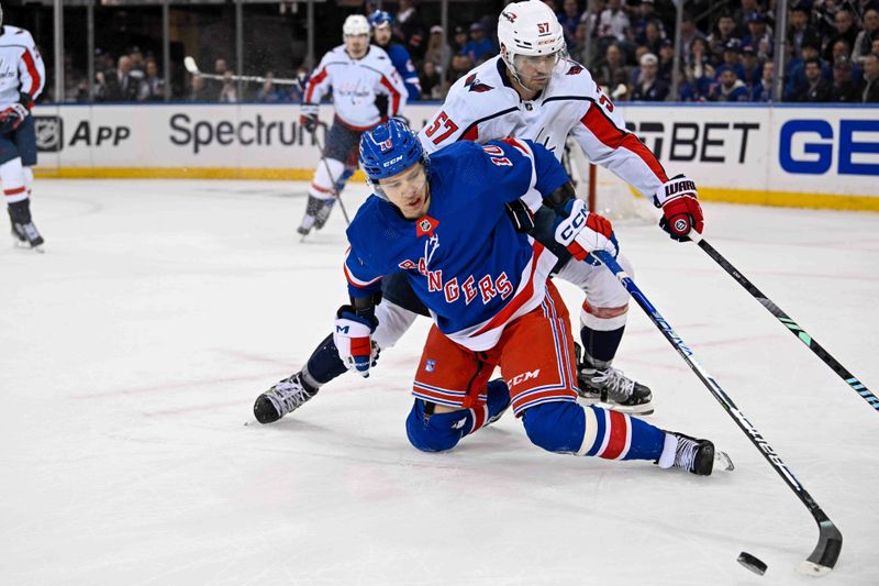 Apr 23, 2024; New York, New York, USA;  Washington Capitals defenseman Trevor van Riemsdyk (57) defends against New York Rangers left wing Artemi Panarin (10) during the first period in game two of the first round of the 2024 Stanley Cup Playoffs at Madison Square Garden. Mandatory Credit: Dennis Schneidler-USA TODAY Sports