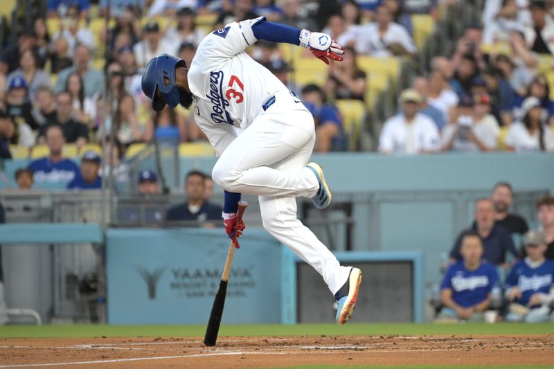 Jul 24, 2024; Los Angeles, California, USA;  Los Angeles Dodgers left fielder Teoscar Hernandez (37) is hit by a pitch in the first inning against the San Francisco Giants at Dodger Stadium. Mandatory Credit: Jayne Kamin-Oncea-USA TODAY Sports