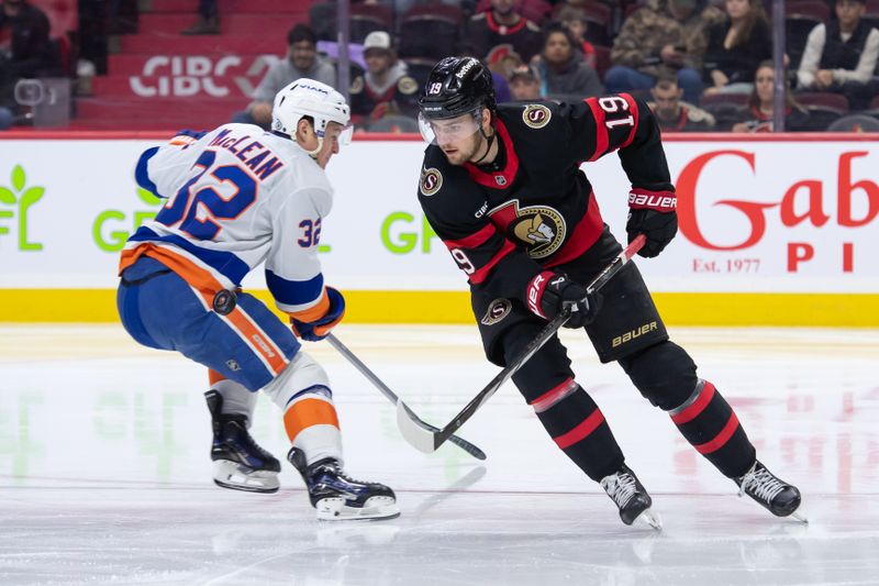 Dec 8, 2024; Ottawa, Ontario, CAN; Ottawa Senators right wing Drake Batherson (19) moves the puck past New York Islanders center Kyle MacLean (32) in the second period at the Canadian Tire Centre. Mandatory Credit: Marc DesRosiers-Imagn Images