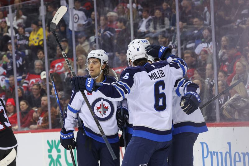 Mar 7, 2025; Newark, New Jersey, USA; Winnipeg Jets left wing Alex Iafallo (9) celebrates his goal against the New Jersey Devils during the first period at Prudential Center. Mandatory Credit: Ed Mulholland-Imagn Images