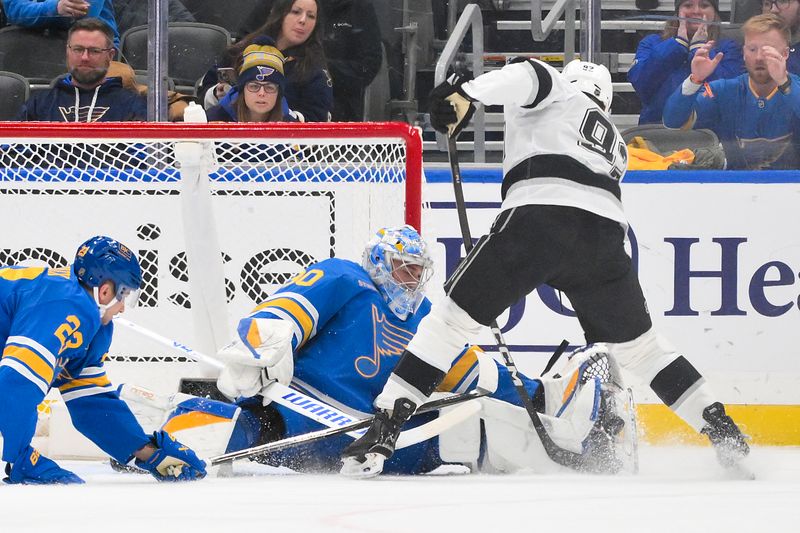 Jan 24, 2026; St. Louis, Missouri, USA; St. Louis Blues goaltender Joel Hofer (30) defends the net against Los Angeles Kings defenseman Brandt Clarke (92) during overtime at Enterprise Center. Mandatory Credit: Jeff Curry-Imagn Images