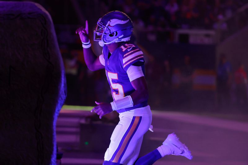 Minnesota Vikings quarterback Joshua Dobbs (15) runs onto the field before an NFL football game against the Chicago Bears, Monday, Nov. 27, 2023, in Minneapolis. (AP Photo/Bruce Kluckhohn)