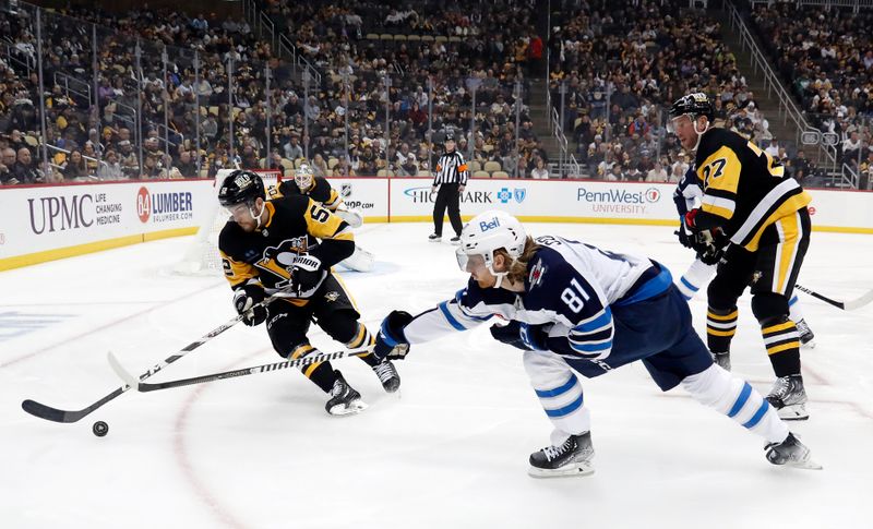 Jan 13, 2023; Pittsburgh, Pennsylvania, USA;  Pittsburgh Penguins defenseman Mark Friedman (52) moves the puck out of the reach of Winnipeg Jets left wing Kyle Connor (81) during the first period against at PPG Paints Arena. Mandatory Credit: Charles LeClaire-USA TODAY Sports