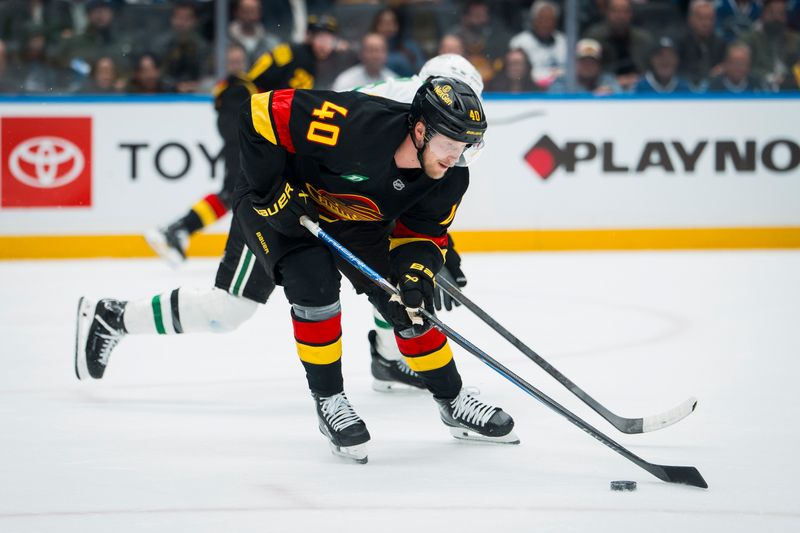 Nov 20, 2025; Vancouver, British Columbia, CAN; Vancouver Canucks forward Elias Pettersson (40) handles the puck against the Dallas Stars in the third period at Rogers Arena. Mandatory Credit: Bob Frid-Imagn Images