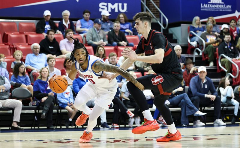 Feb 1, 2025; Dallas, Texas, USA;  Southern Methodist Mustangs guard B.J. Edwards (0) drives to the basket as Stanford Cardinal forward Maxime Raynaud (42) defends  during the first half at Moody Coliseum. Mandatory Credit: Kevin Jairaj-Imagn Images