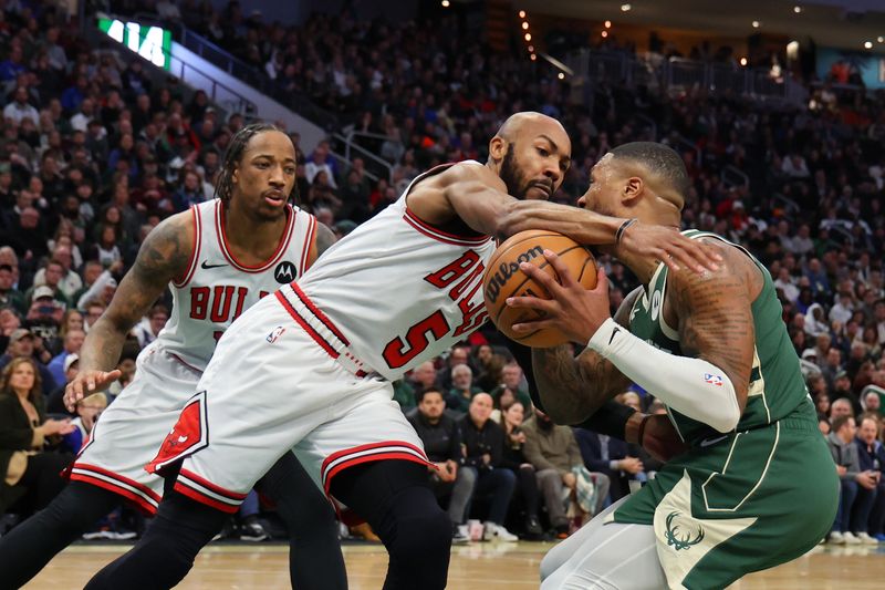 MILWAUKEE, WISCONSIN - DECEMBER 11: Jevon Carter #5 of the Chicago Bulls strips the ball from Damian Lillard #0 of the Milwaukee Bucks during a game at Fiserv Forum on December 11, 2023 in Milwaukee, Wisconsin. NOTE TO USER: User expressly acknowledges and agrees that, by downloading and or using this photograph, User is consenting to the terms and conditions of the Getty Images License Agreement. (Photo by Stacy Revere/Getty Images)