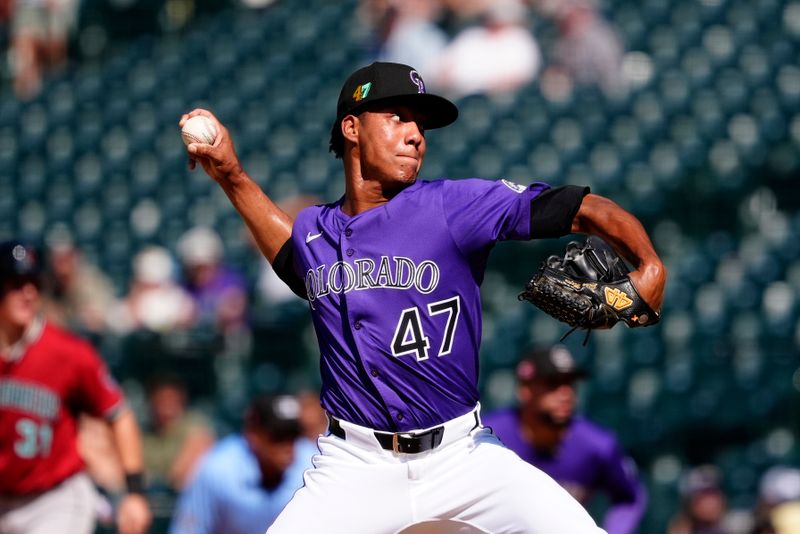 Aug 17, 2025; Denver, Colorado, USA; Colorado Rockies relief pitcher Juan Mejia (47) delivers a pitch in the ninth inning against the Arizona Diamondbacks at Coors Field. Mandatory Credit: Ron Chenoy-Imagn Images