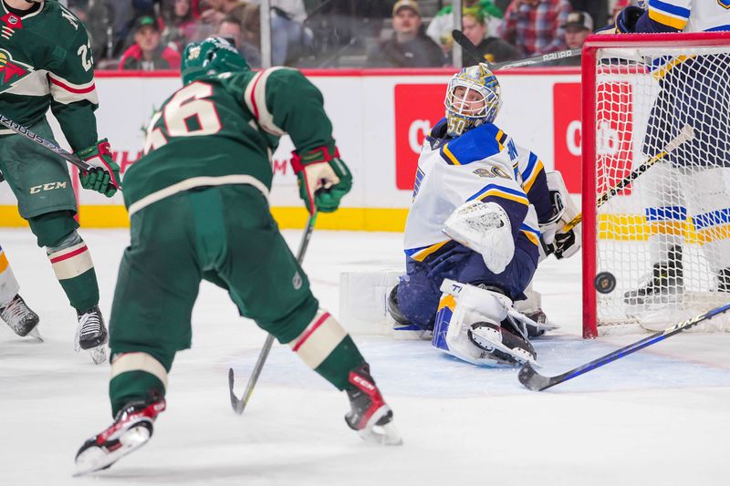 Nov 28, 2023; Saint Paul, Minnesota, USA; Minnesota Wild defenseman Jared Spurgeon (46) misses the net against the St. Louis Blues goaltender Jordan Binnington (50) in the second period at Xcel Energy Center. Mandatory Credit: Brad Rempel-USA TODAY Sports