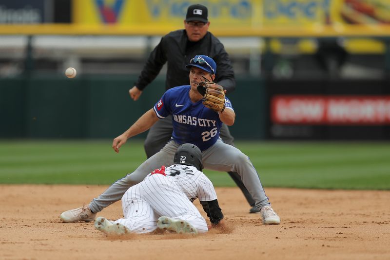 Apr 17, 2024; Chicago, Illinois, USA; Chicago White Sox outfielder Andrew Benintendi (23) slides into second base as Kansas City Royals second base Adam Frazier (26) waits for the ball in the fourth inning during game one of a double header at Guaranteed Rate Field. Mandatory Credit: Melissa Tamez-USA TODAY Sports